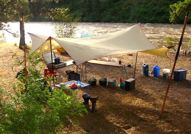 Tent Sitting on The Ground Next to A River