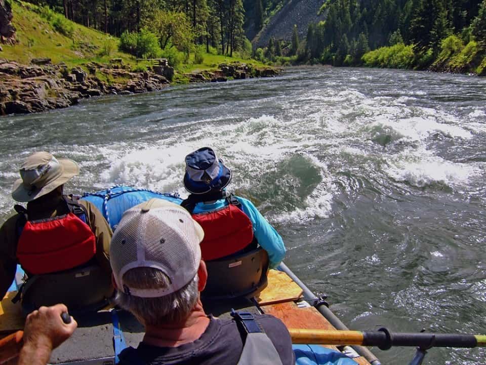 A group of people are rafting down a river