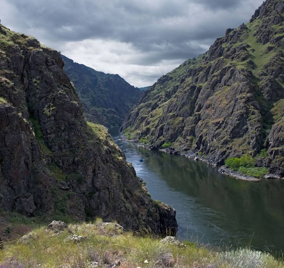 A river runs through a canyon between two mountains