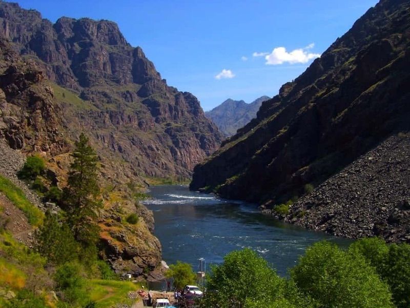 River flowing through a canyon with mountains in the background