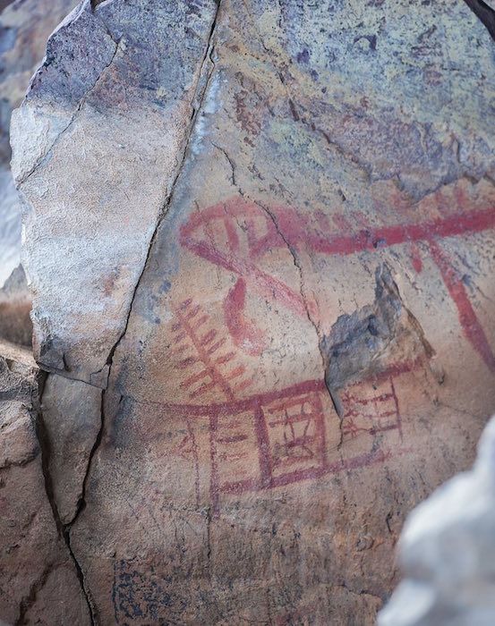 A close up of a rock with a painting on it