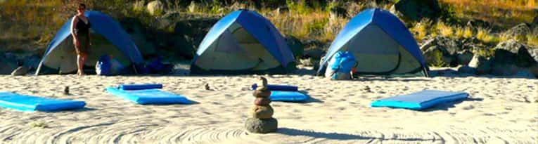 Blue Tents Sitting on A Sandy Beach