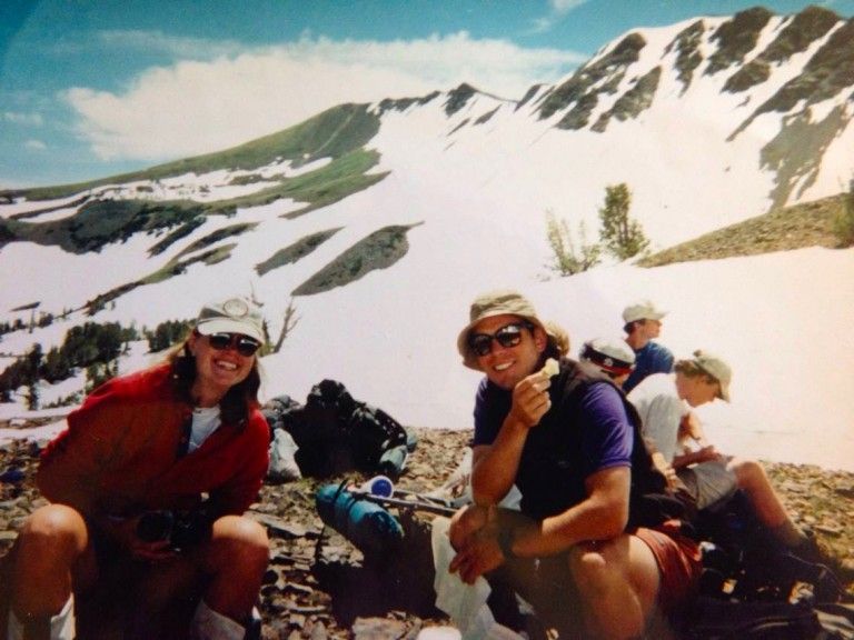People Sitting on Top of A Snow Covered Mountain