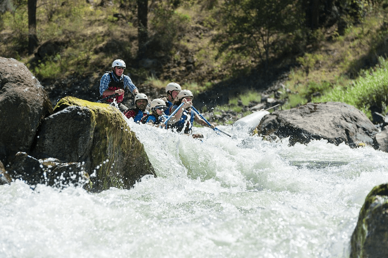 A Group of People Are Rafting Down a River