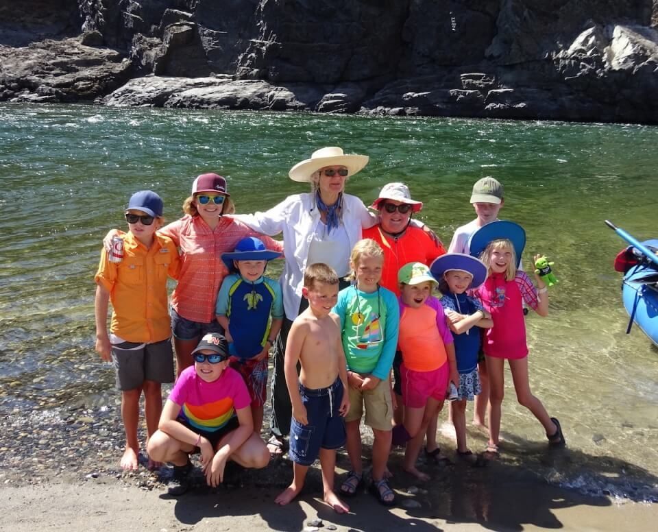 a group of kids in front of the water