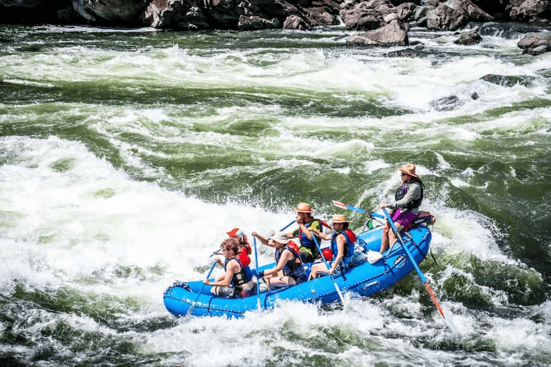 A Group of People Are Rafting Down a River