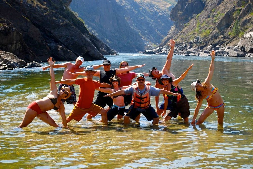 A Group of People Are Posing for A Picture in the Water