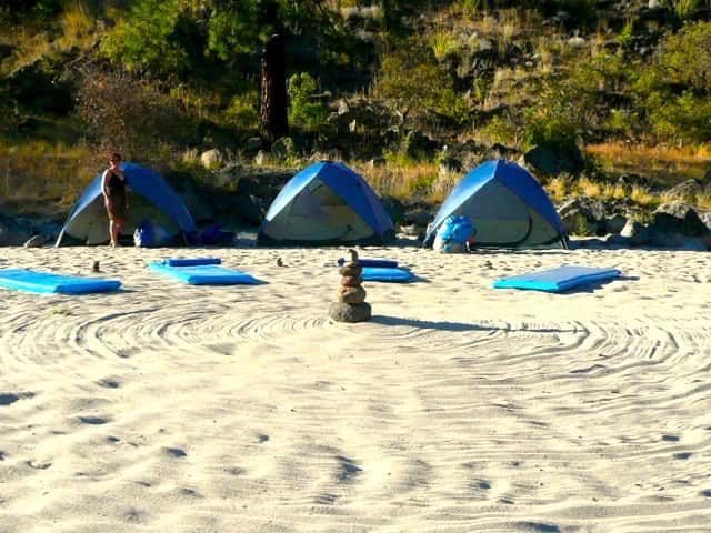 Circle of Yoga Mats and Tents on A Sandy Beach