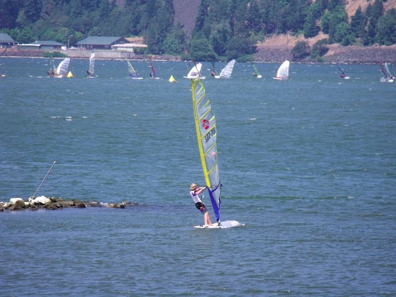 A person is windsurfing on a large body of water