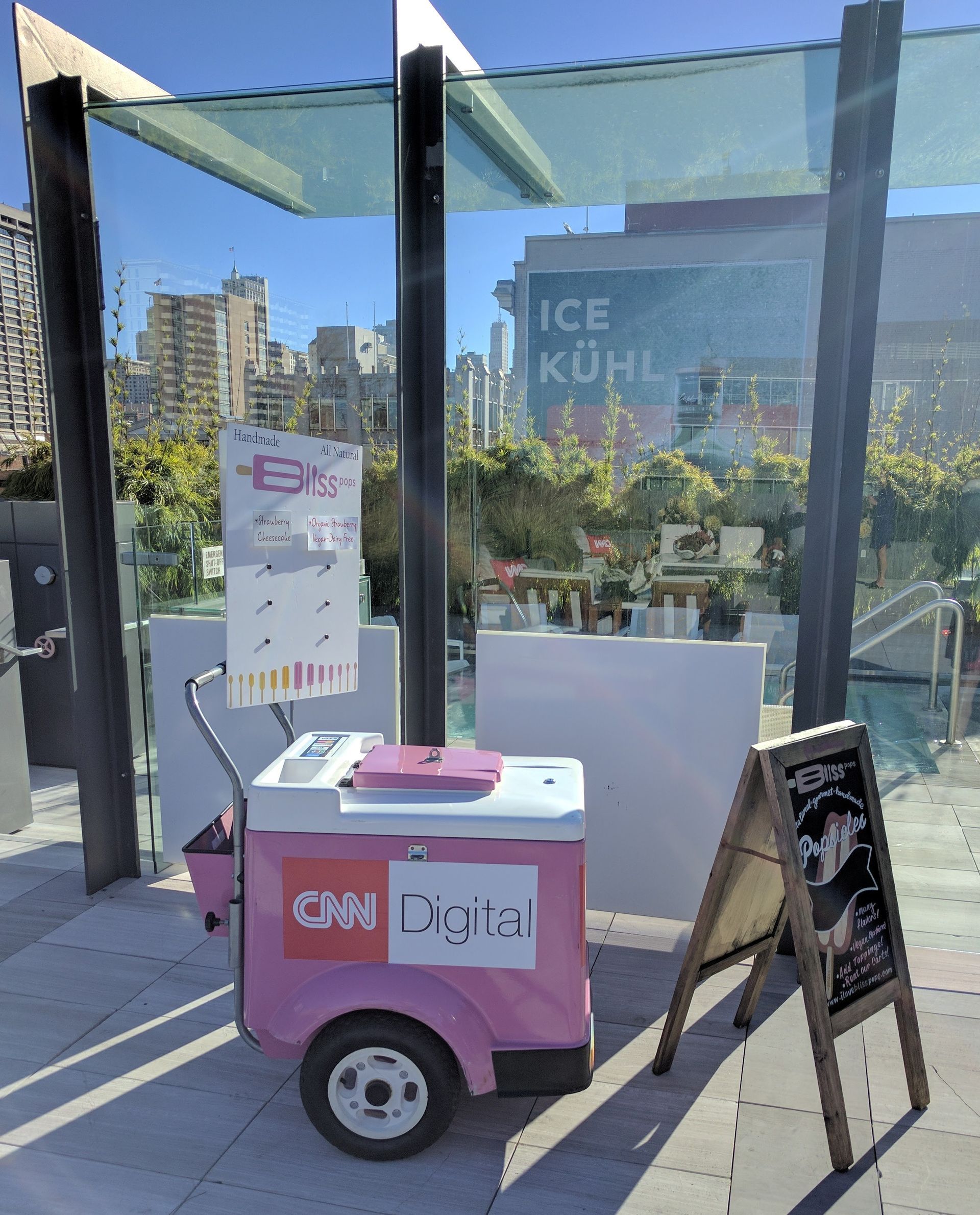A pink cart with cnn digital written on it