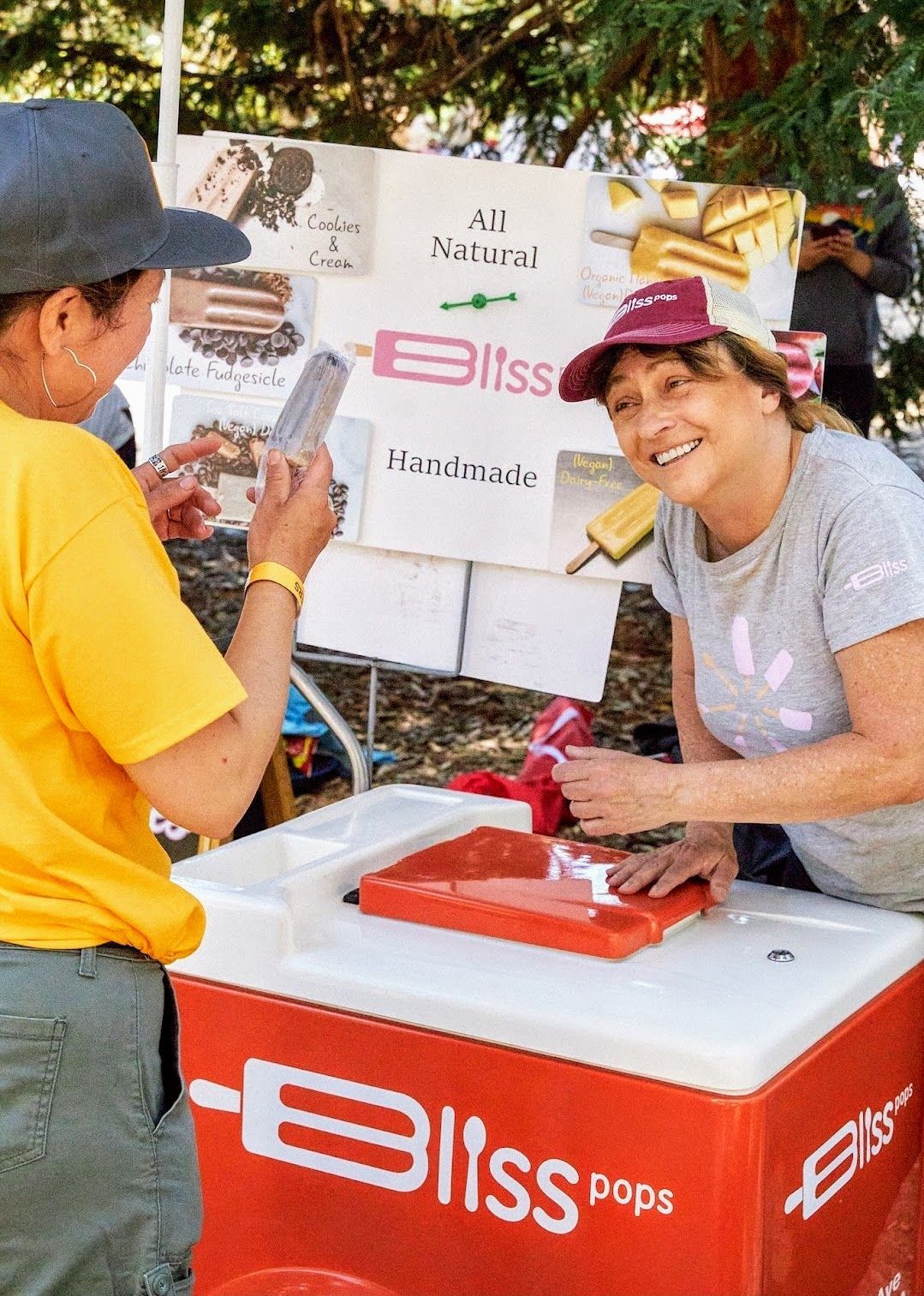 A man standing next to a pink bliss cooler