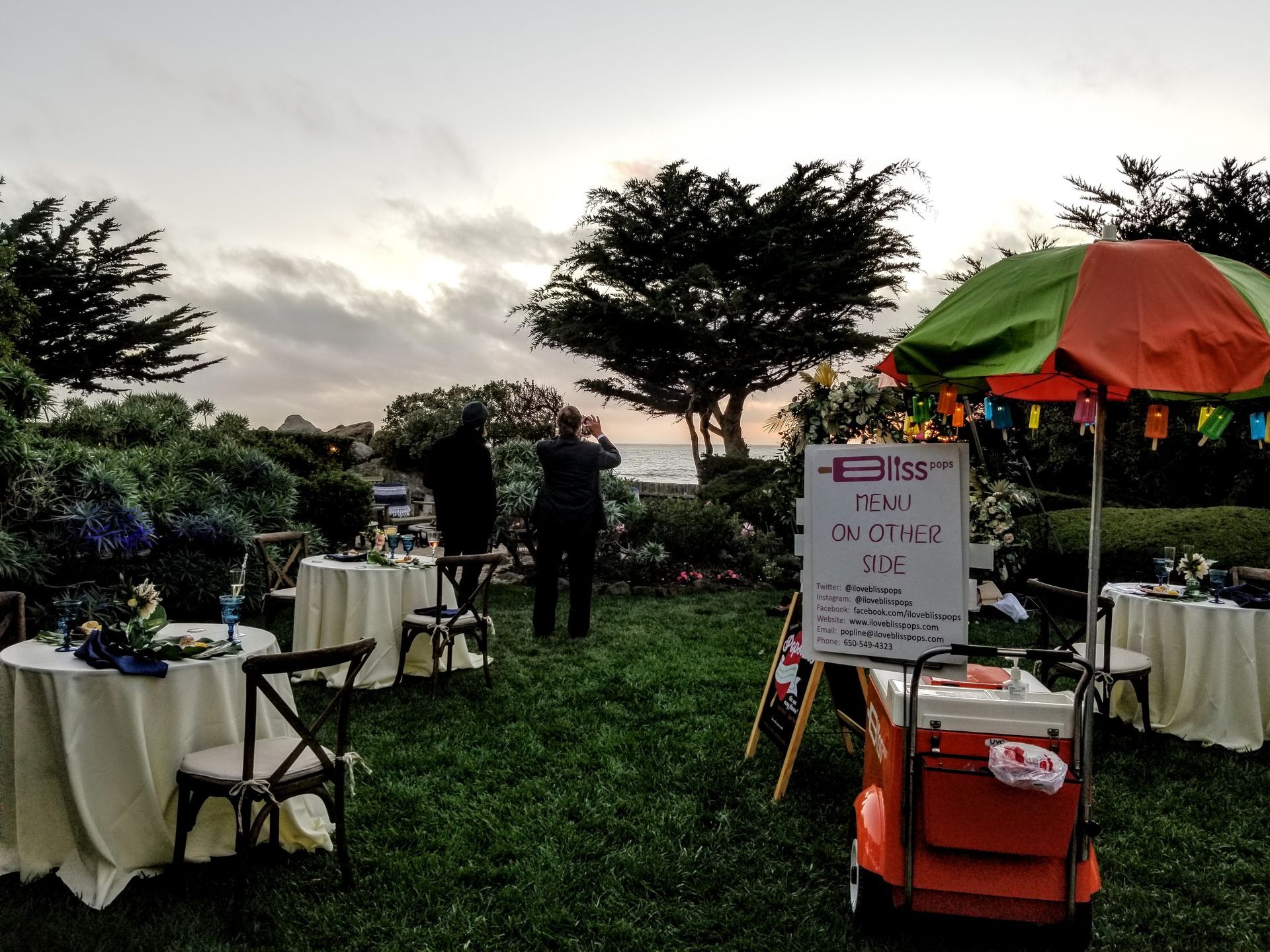A lawn with tables and chairs and a sign that says ' efes ' on it