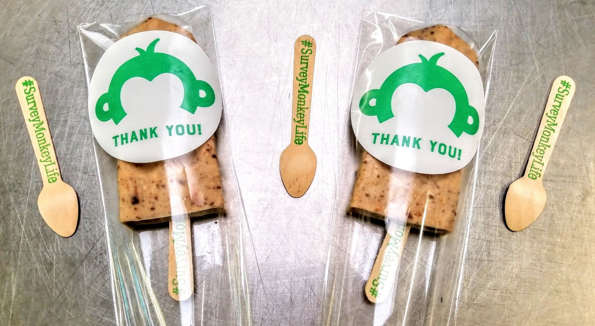 A couple of popsicle sticks with thank you stickers on them
