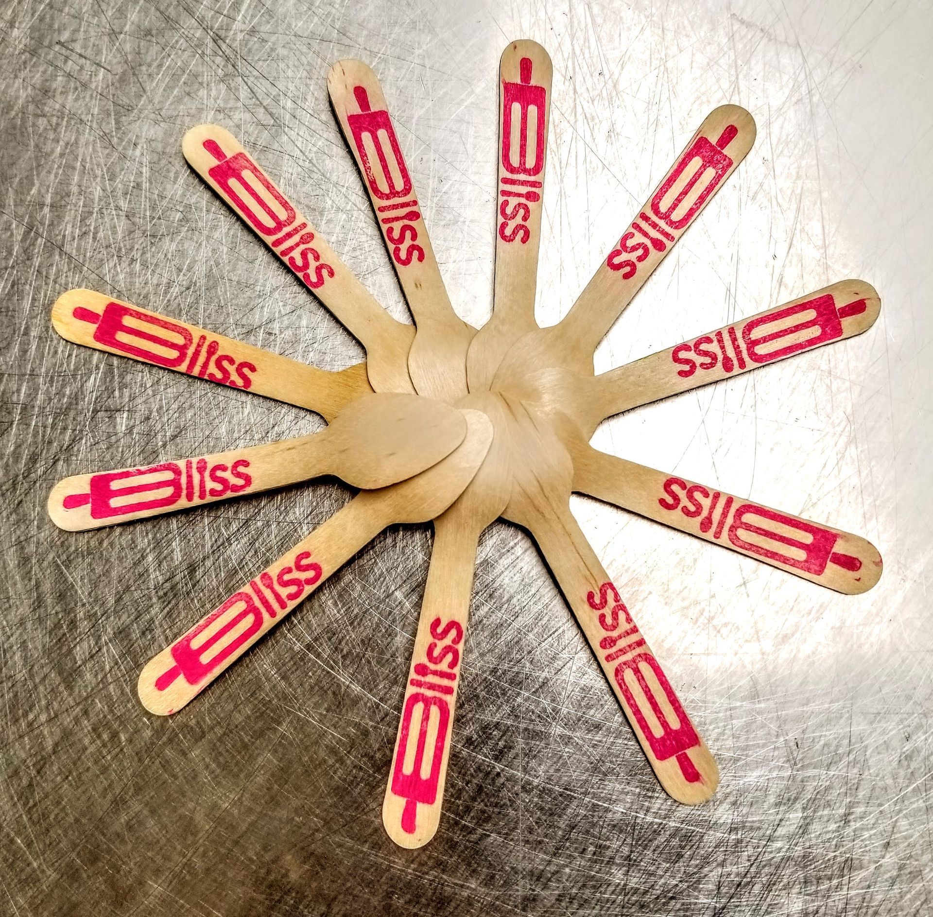 A bunch of wooden spoons with bliss written on them