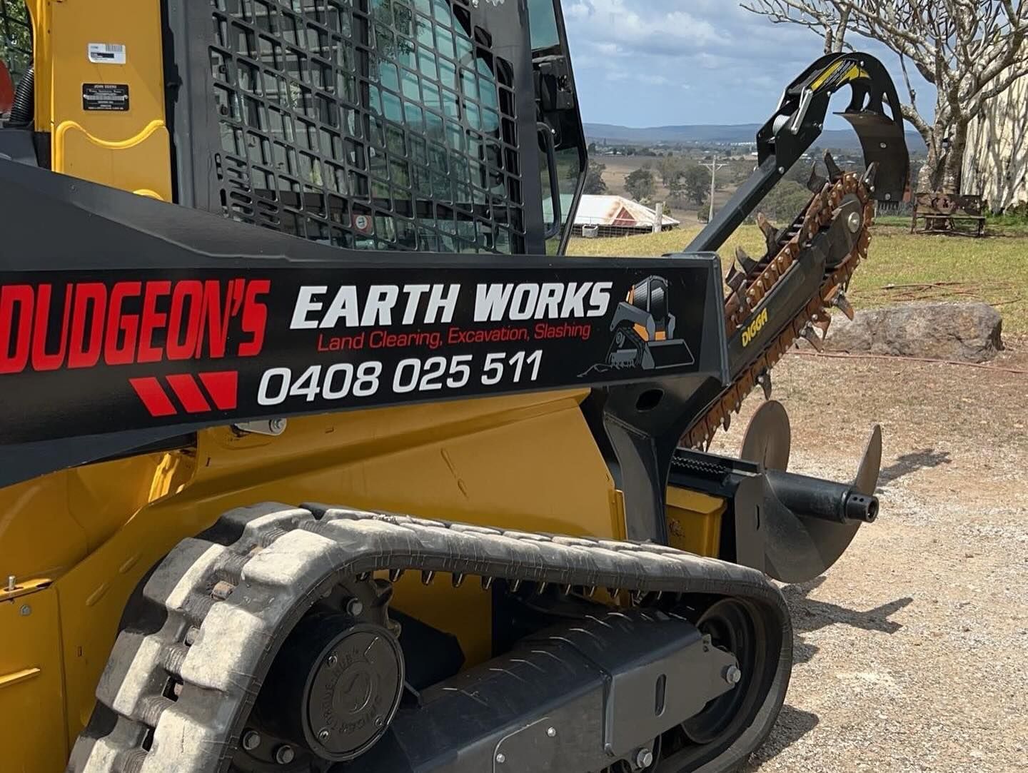 Yellow Skid Steer With Dudgeon's Earth Works Logo — Dudgeon’s Earthworks in Murgon, QLD