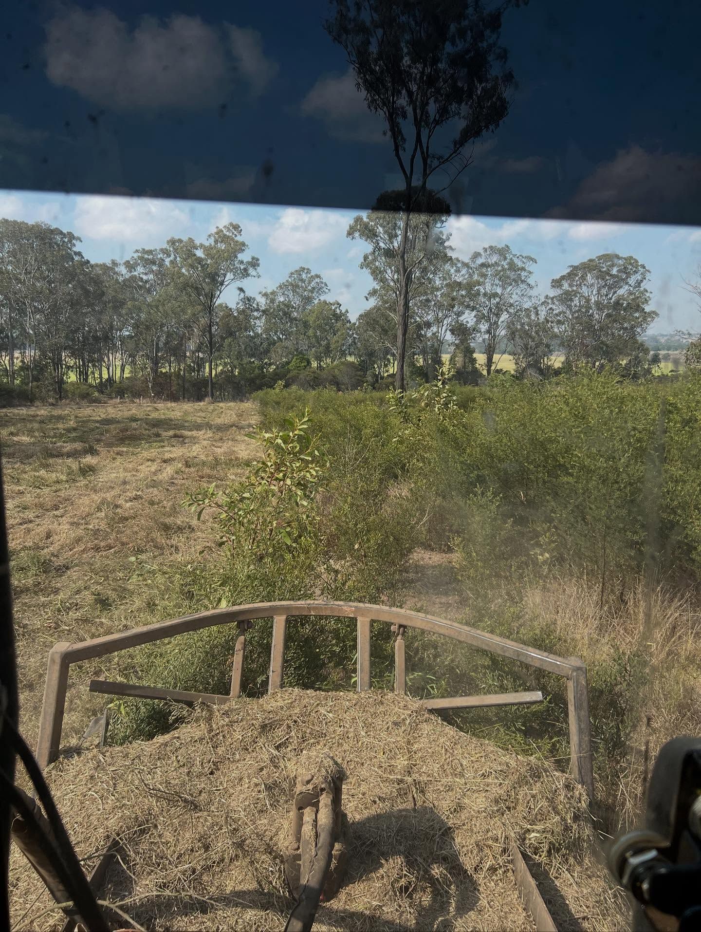 View From a Vehicle's Windshield, Looking Over a Pile of Mulch — Dudgeon’s Earthworks in Murgon, QLD