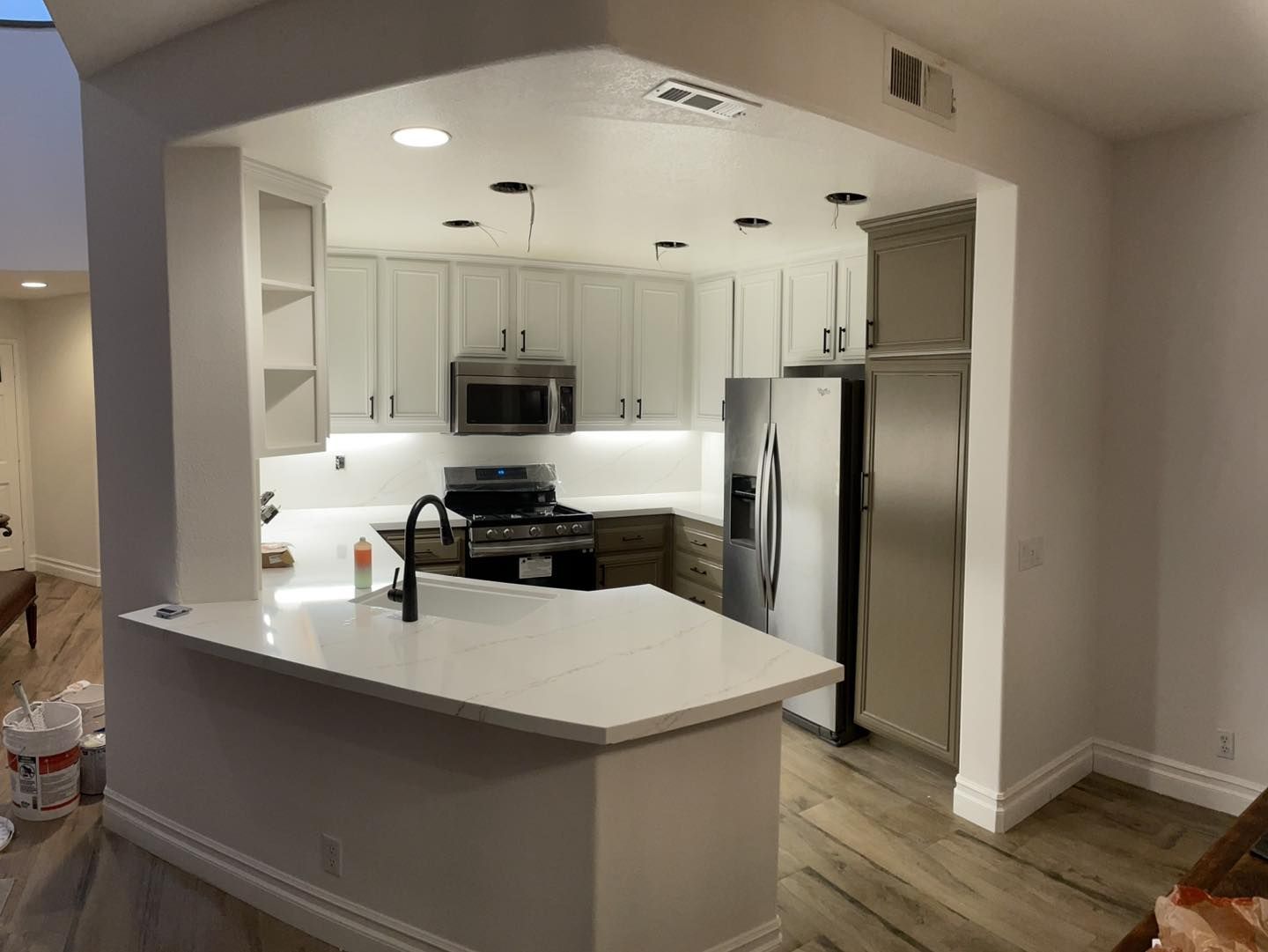 After picture of the same kitchen, now fully remodeled. The kitchen looks much more modern with more light. 