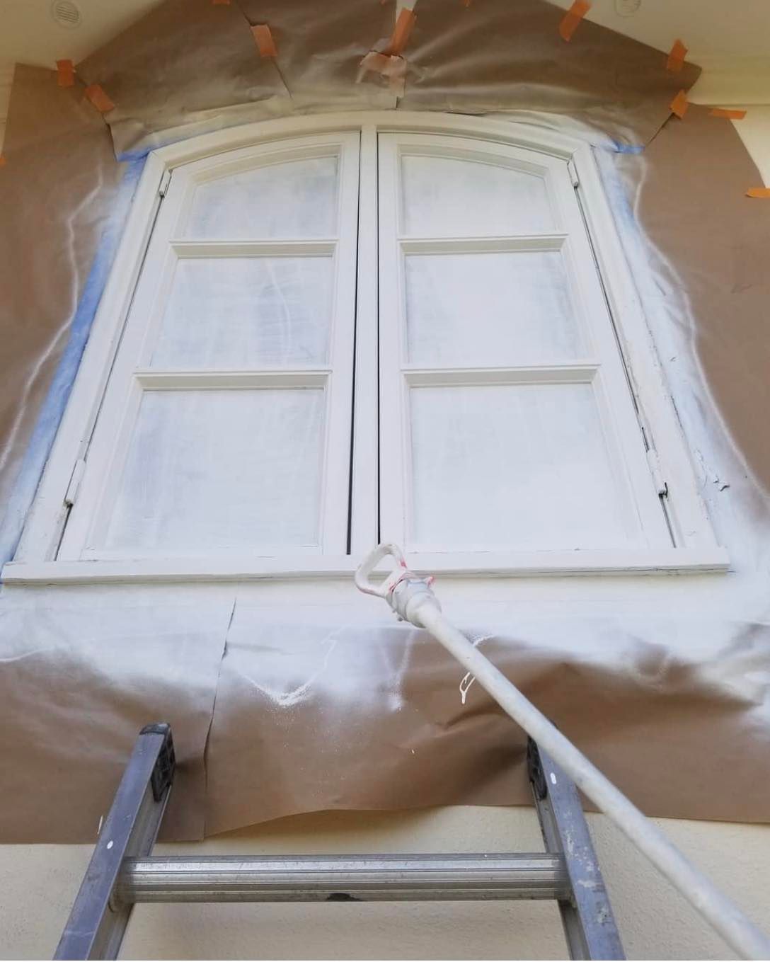 Image of a front door that is being repainted by the guys of Desert innovations painting and handyman in Coachella Valley.