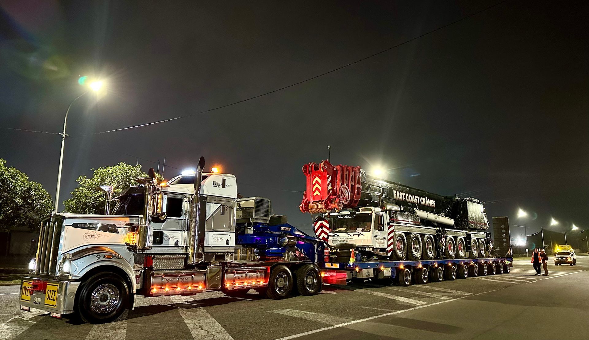 Large Trucks Hauling Heavy Crane Equipment at Night — ECC Heavy Haulage in Ormeau, QLD