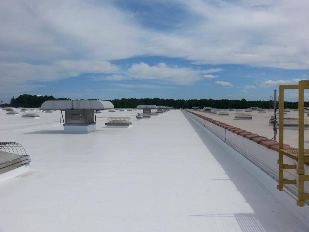 A large white roof with a lot of vents on it