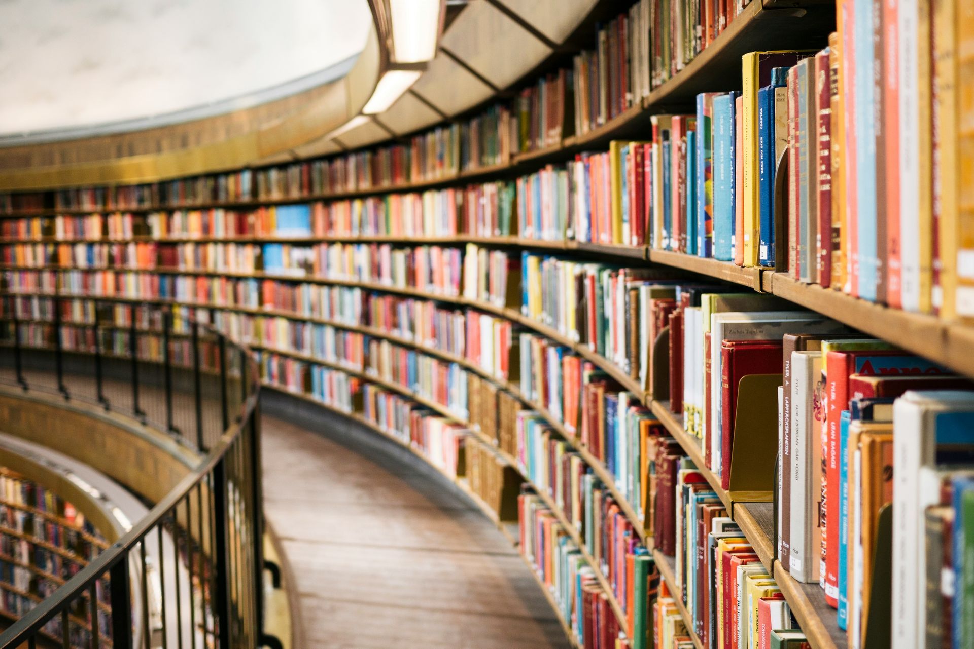 Curved rows of bookshelves filled with books inside a library