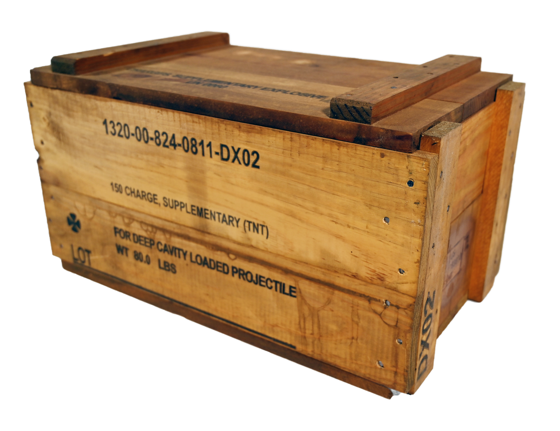 Wooden box on a green table with a military vehicle and guard tower in the background.