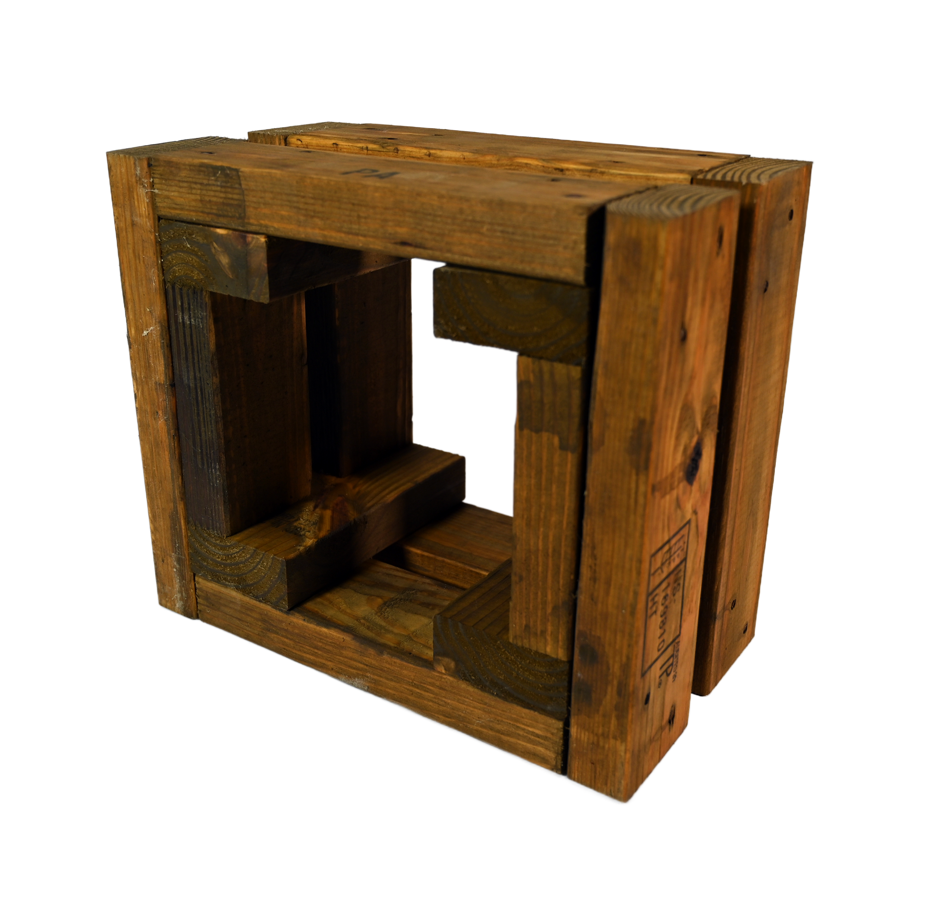Wooden box frame under construction, set on a plywood surface with tools, in a workshop.