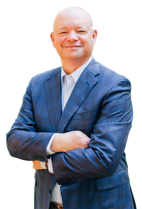 Jim Colvin in a blue suit with arms crossed, smiling, posing for a photo.