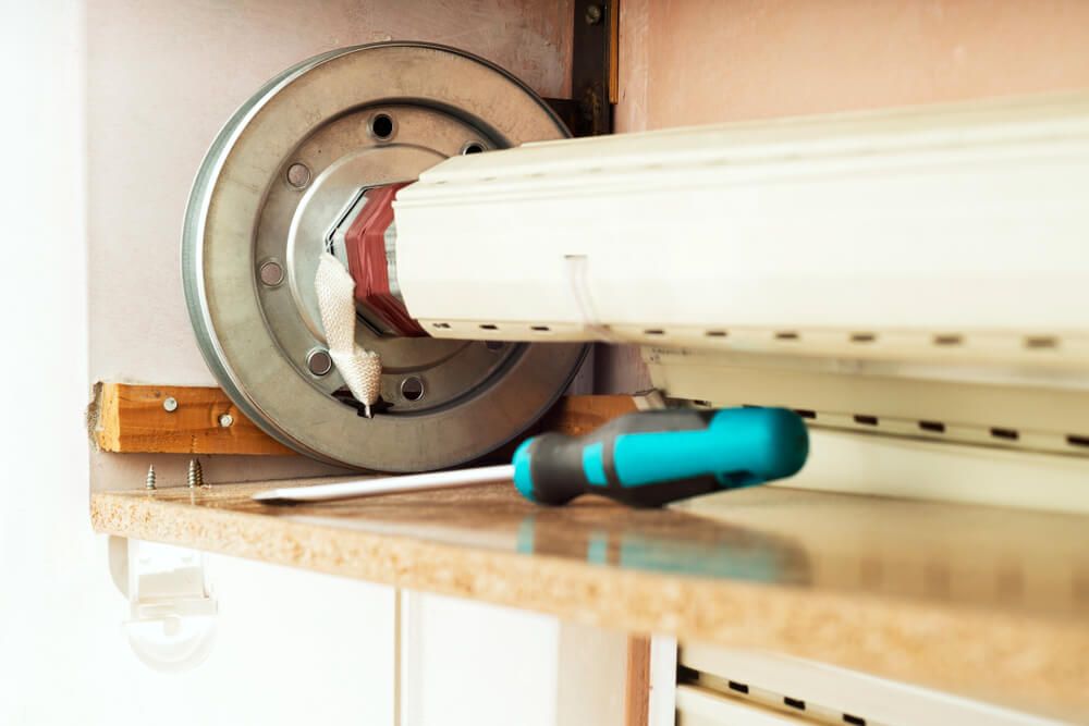 A Screwdriver is Sitting on a Counter Next to a Roller Shutter — Wow Clean Cairns in Edmonton, QLD