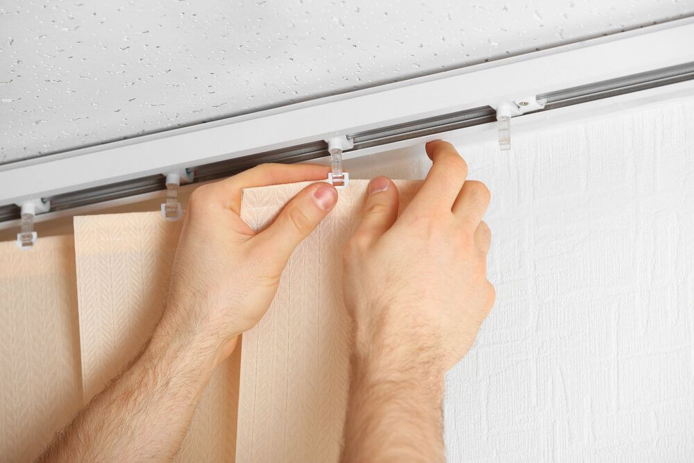 Male Hands Installing Vertical Blinds — Wow Clean Cairns in Bayview Heights, QLD