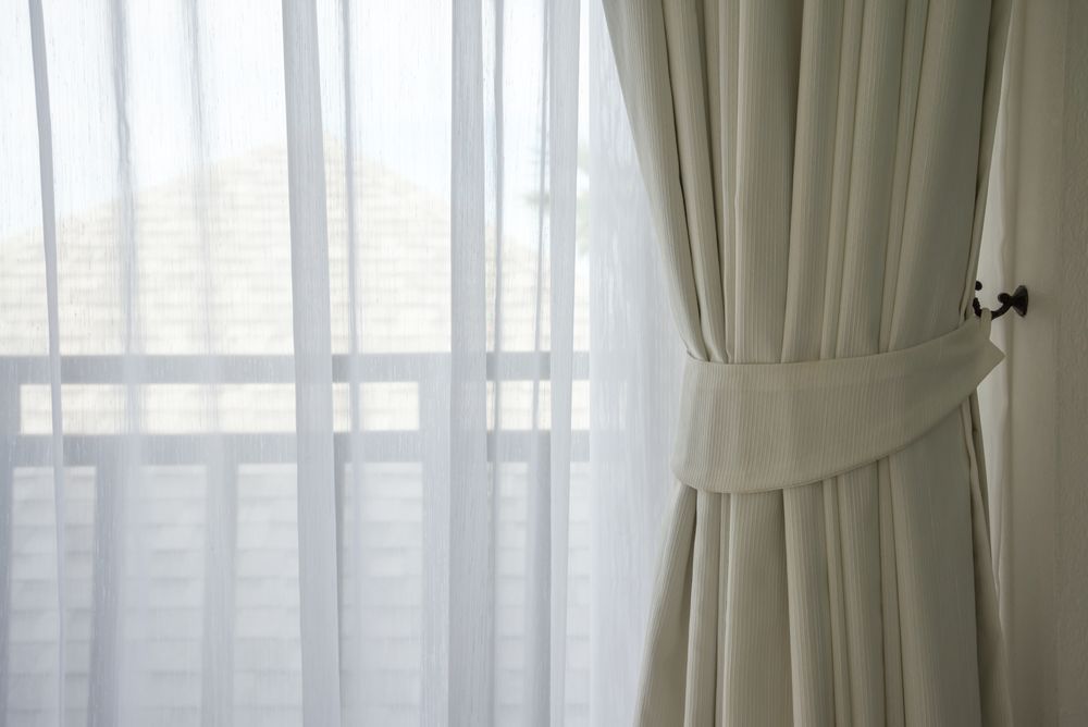 A Close Up of a Pair of White Curtains Hanging on a Window — Wow Clean Cairns in Edmonton, QLD