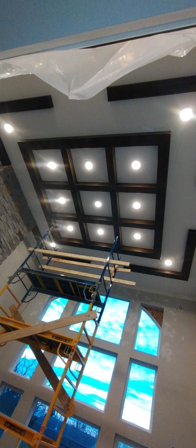 Ceiling with recessed square lights and blue stained-glass windows in a modern interior