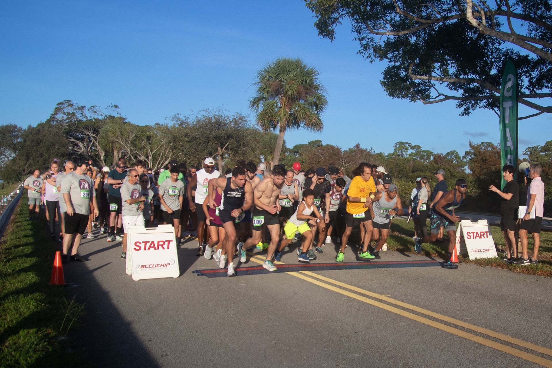 A group of people are running a race on a road.
