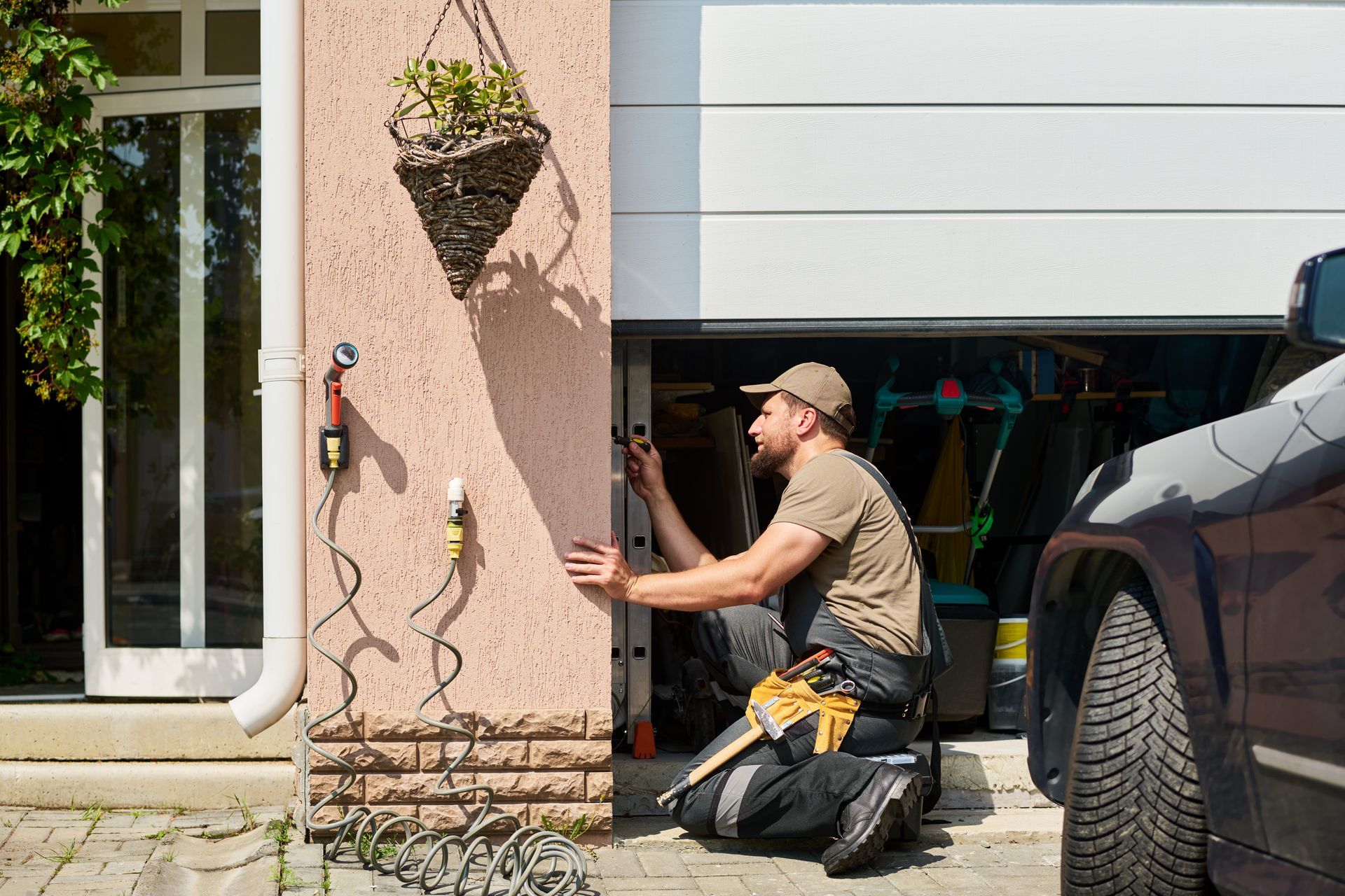 A technician repairing an automatic garage door system.