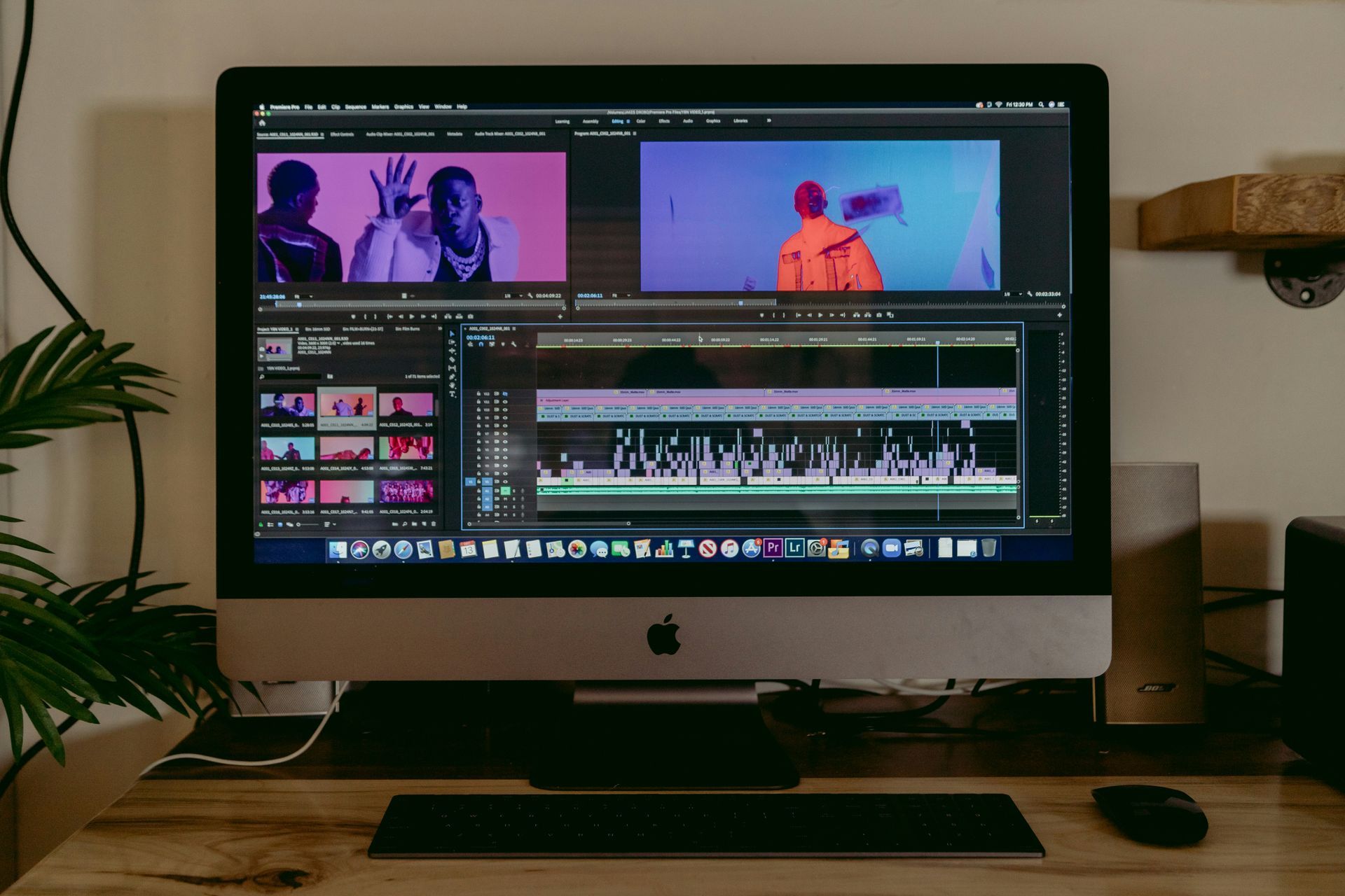 Desktop computer displaying video editing software interface with two video previews and a timeline.