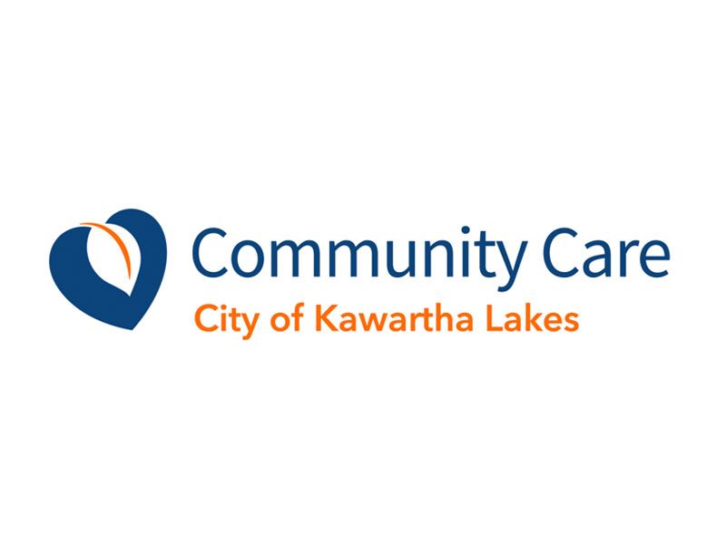 Logo for Community Care City of Kawartha Lakes, featuring a stylized blue heart icon with an orange leaf shape inside.