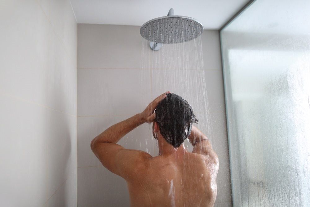 Man in a Hot Water Shower  — Electrical Services  in Jensen, QLD