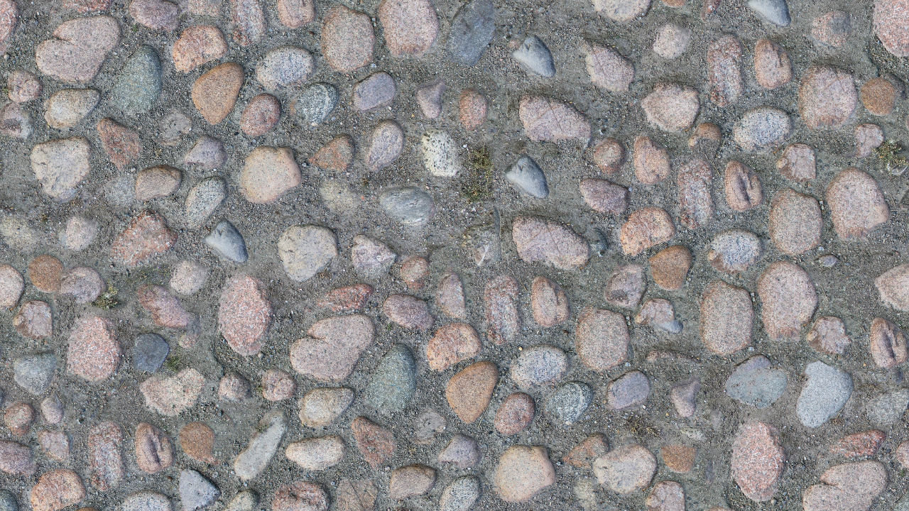 Cobblestone path, pink and gray stones set in concrete.