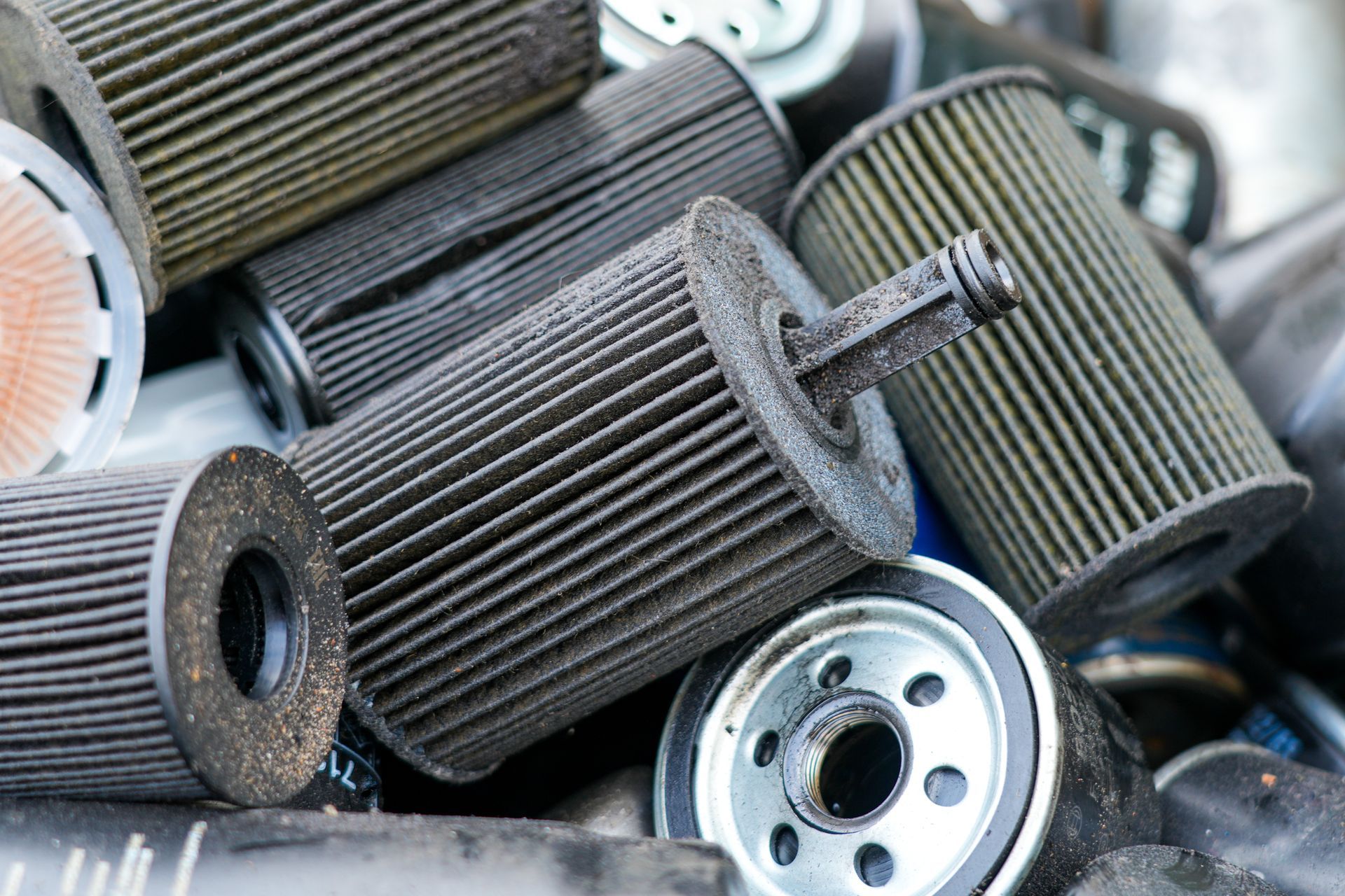 Used oil filters piled in a scrap heap