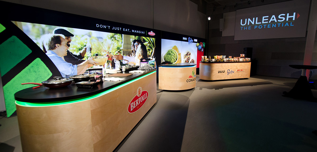 Exhibit with multiple booths that have chef stations