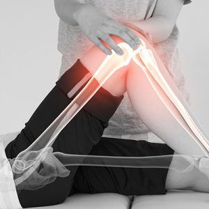 Person receiving physical therapy on knee, highlighted with red and skeletal overlay.
