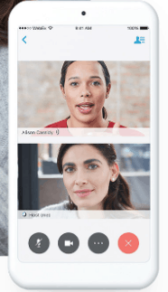Video call on a smartphone showing two women. One is speaking, the other is listening.