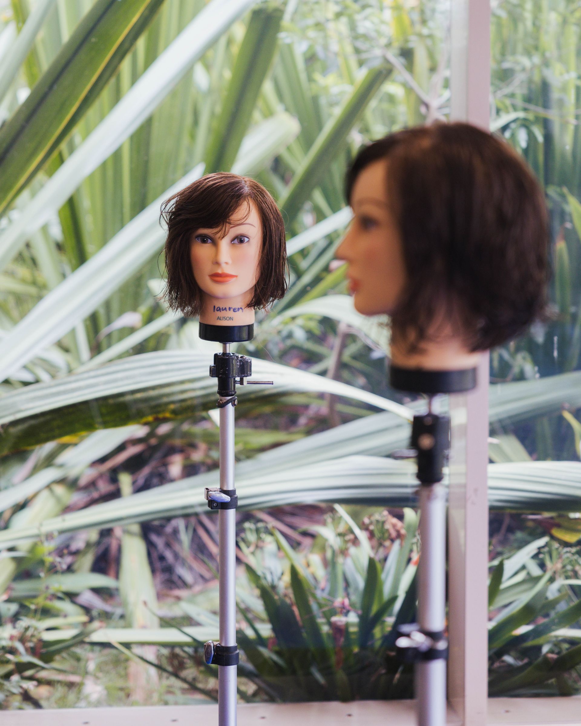 A hairdressing mannequinin a workshop room.