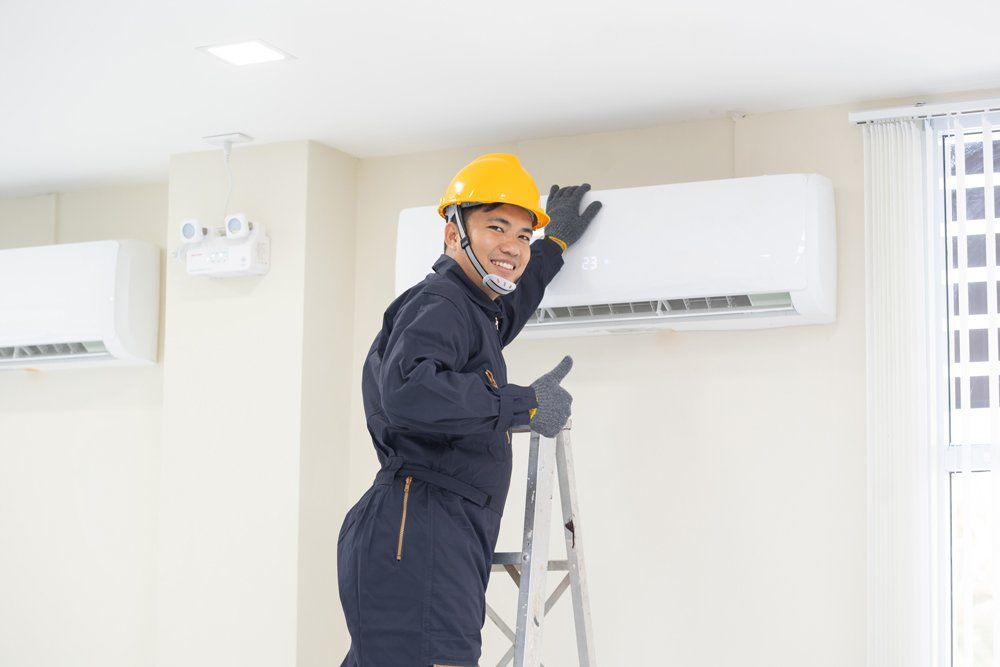 Technician Are Repairing Air Conditioner in Room — South Bend, IN — Ernsperger Air Conditioning & Heating Inc