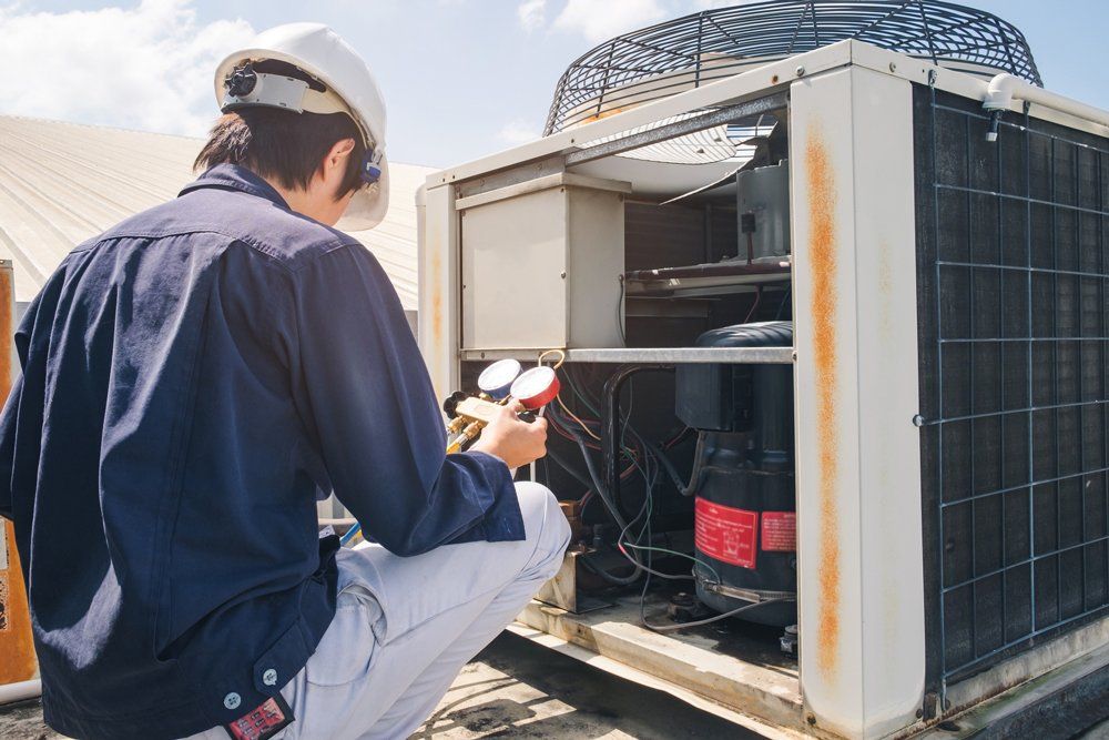 Technician Is Checking Air Conditioner — South Bend, IN — Ernsperger Air Conditioning & Heating Inc