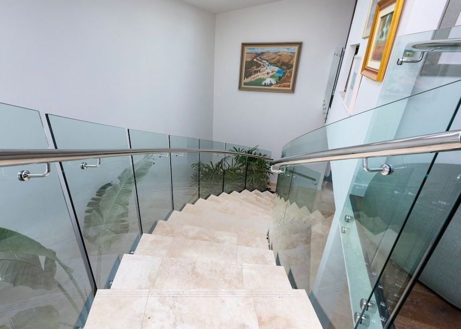 A Staircase With A Glass Railing And A Picture On The Wall  — Star Glass Design Pty Ltd in Mayfield, NSW