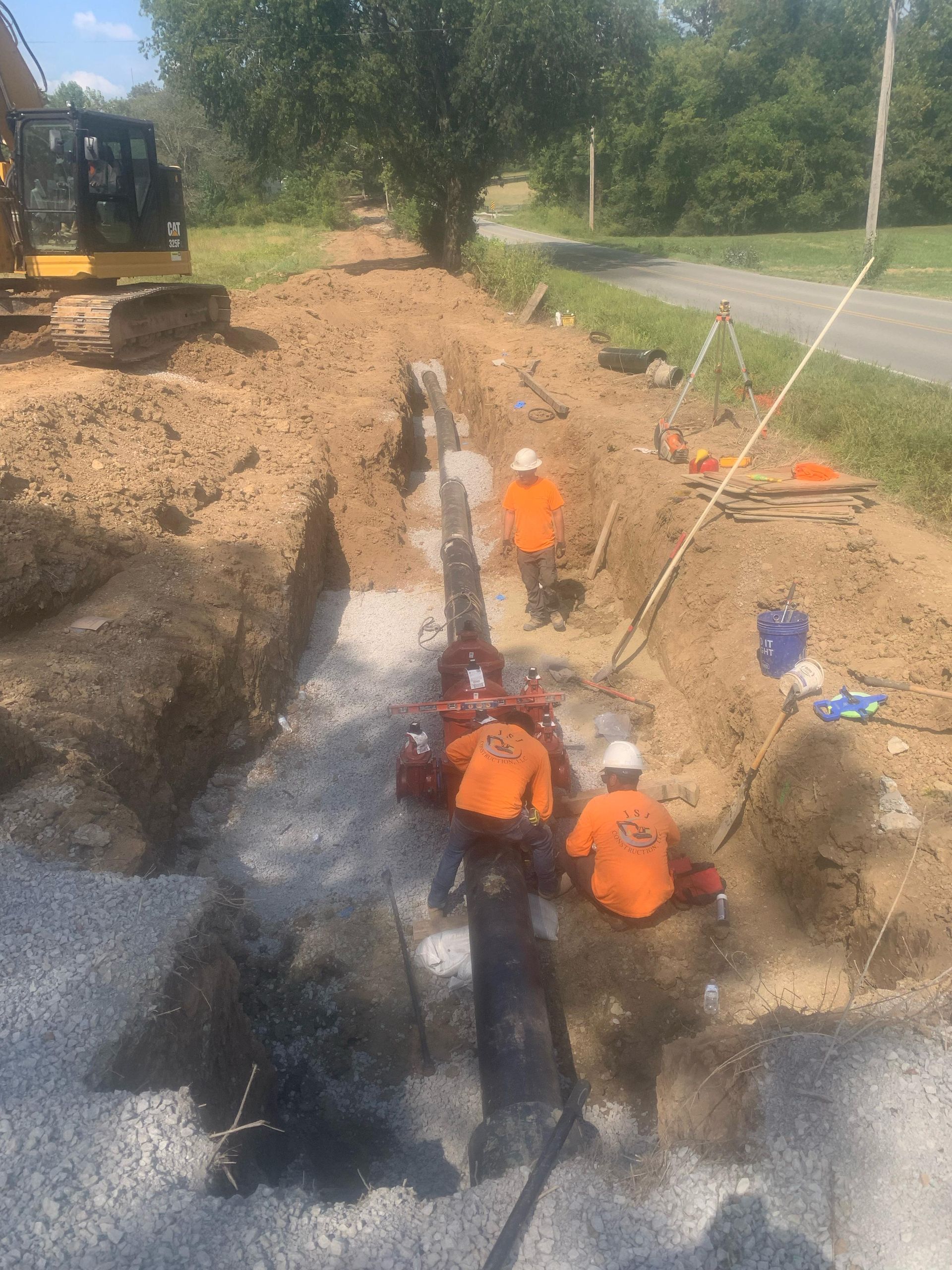 A group of construction workers are digging a hole in the ground.