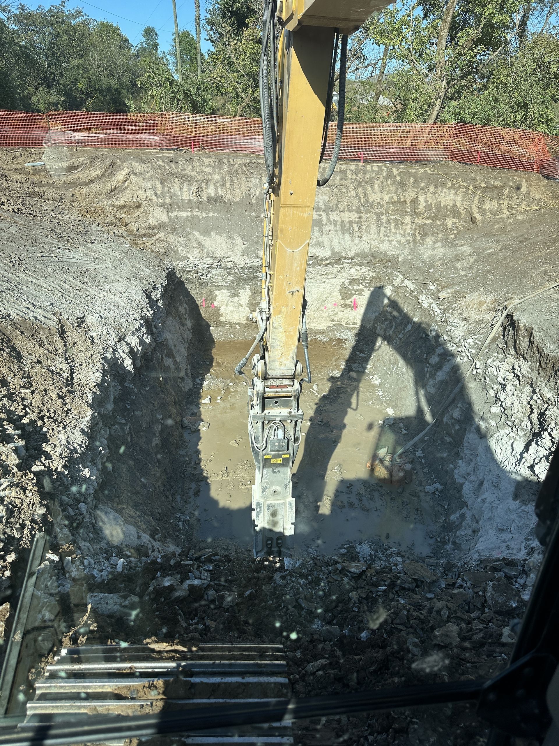 A large excavator is digging a hole in the ground.