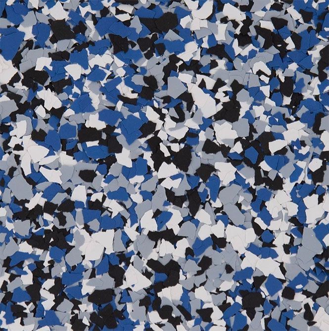 A close-up of decorative vinyl flakes for flooring in a mix of blue, grey, white, and black fragments.