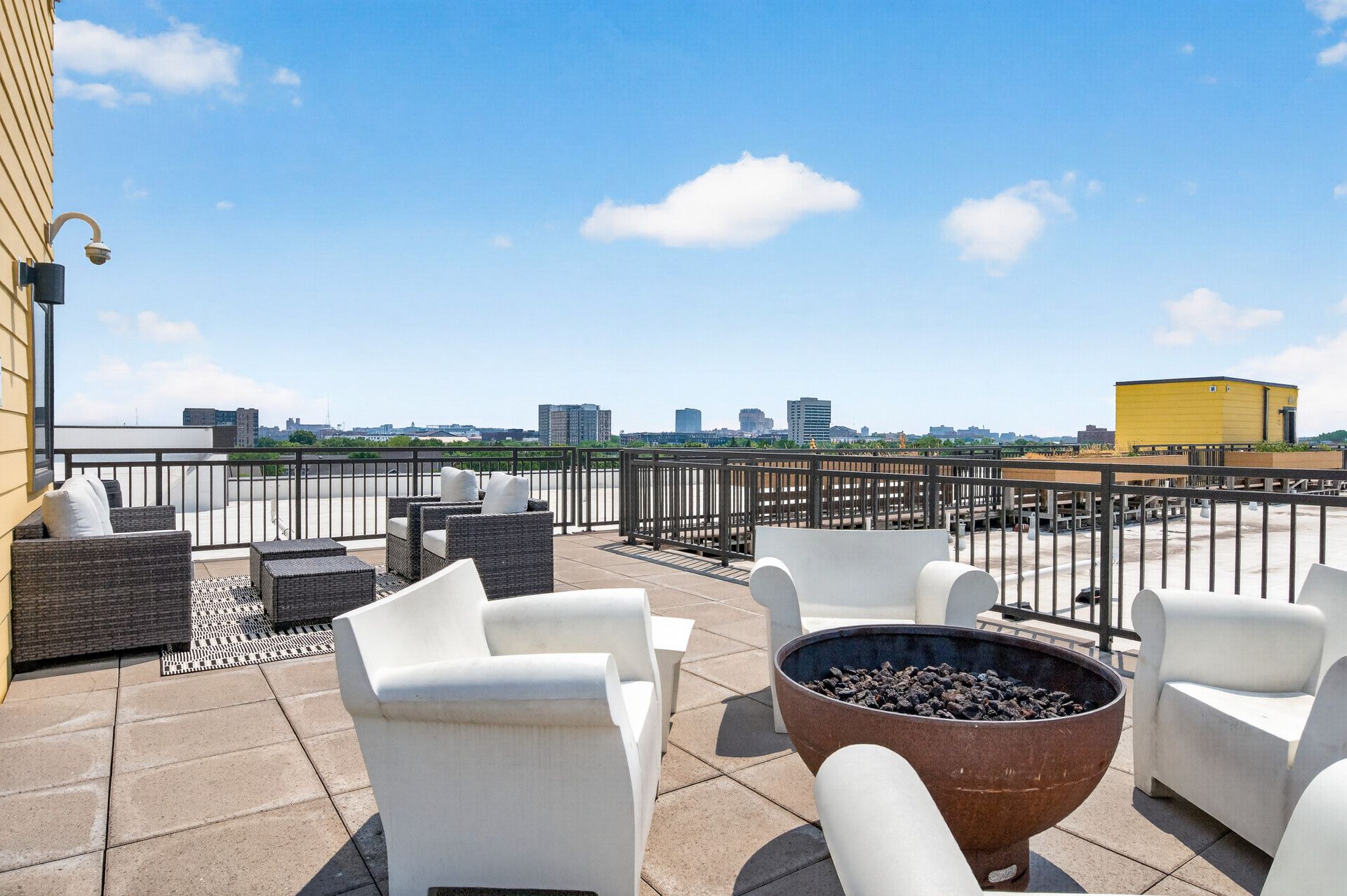 Rooftop lounge area with the Minneapolis skyline in the background at Spectrum Apartments